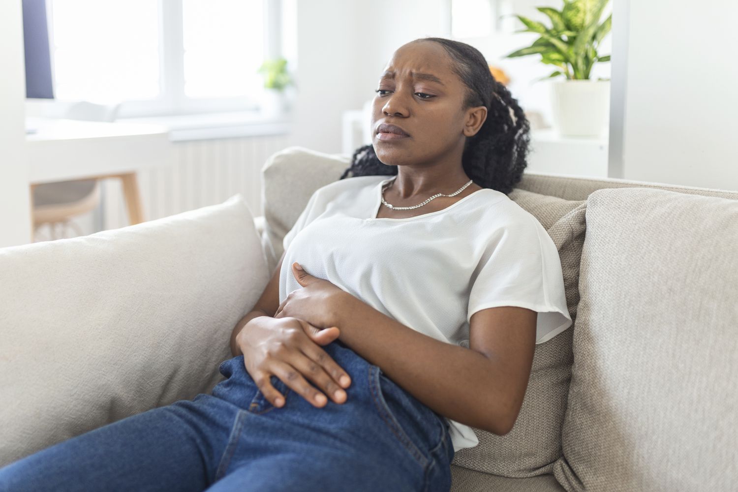 image of a lady holding her stomach